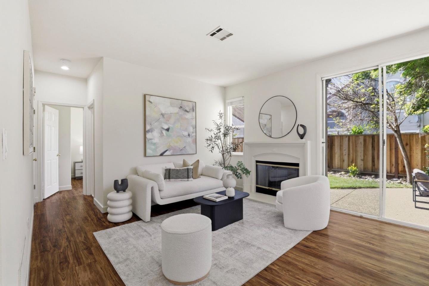 34237 Tupelo Street Fremont, CA 94555 - Photo 11 of 33 a living room with furniture a fireplace and a floor to ceiling window