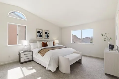 a bedroom with a bed and a lamp with window