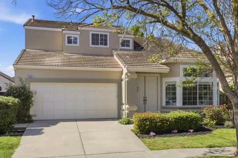 a view of a house with a yard and plants