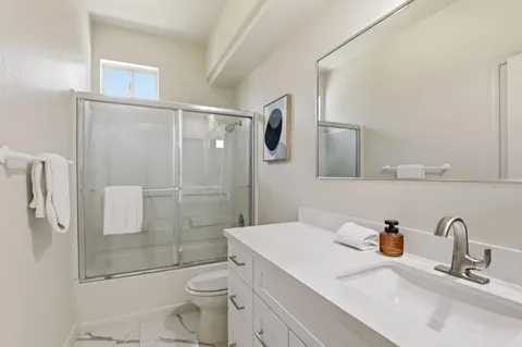 a bathroom with a sink toilet and shower