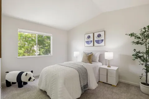 a bedroom with bed and a window