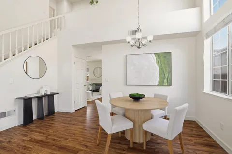 a view of a dining room with furniture and a chandelier