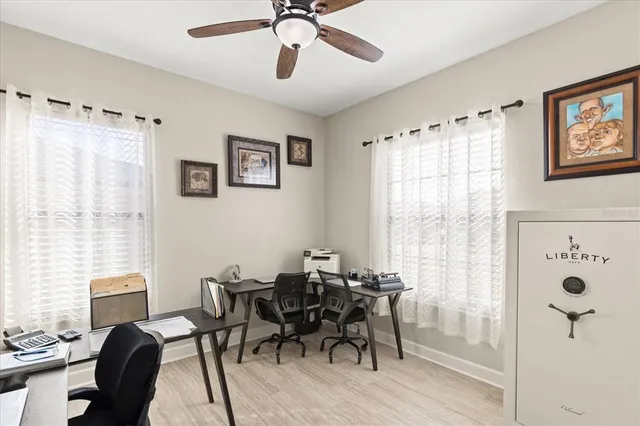 a view of a livingroom and a dining room with furniture window and wooden floor