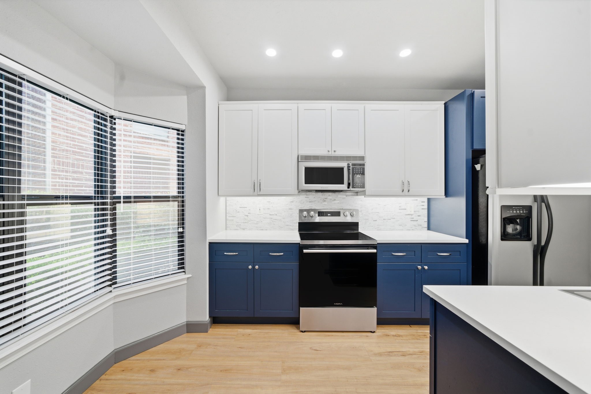 7447 Cambridge Street, Unit 65 Houston, TX 77054 - Photo 18 of 42 a kitchen with stainless steel appliances granite countertop a stove a refrigerator and a microwave