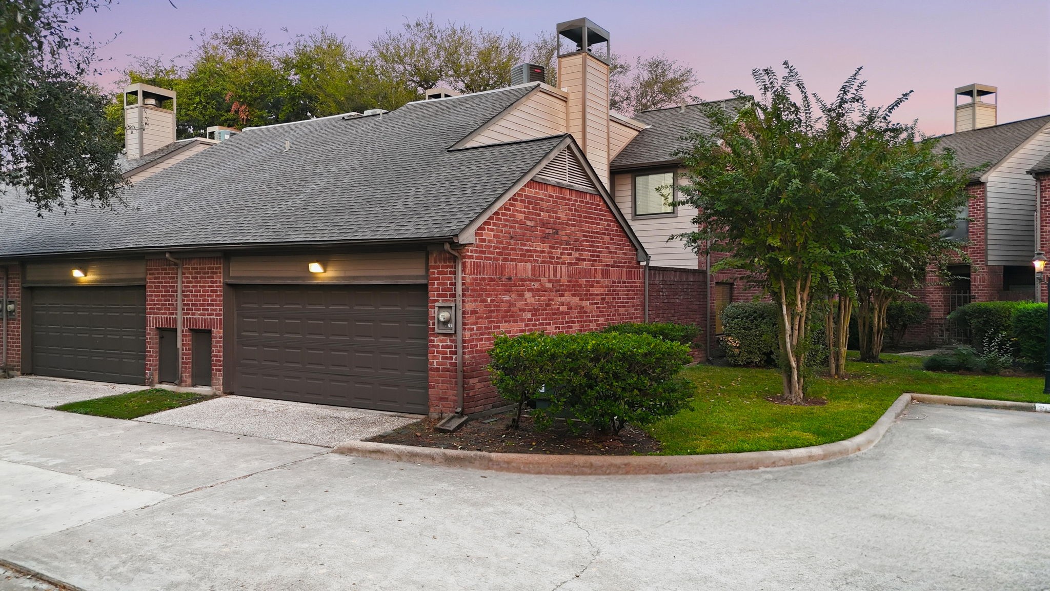 7447 Cambridge Street, Unit 65 Houston, TX 77054 - Photo 10 of 42 a view of a house with a small yard and a large parking space