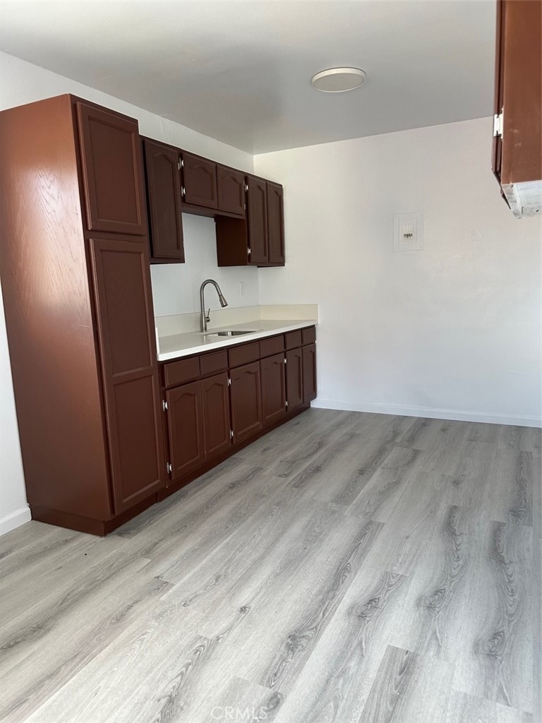 16948 Reed Street, Unit D Fontana, CA 92336 - Photo 1 of 1 a kitchen with stainless steel appliances granite countertop a refrigerator and a sink