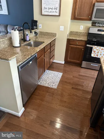 a kitchen with a sink and a stove top oven