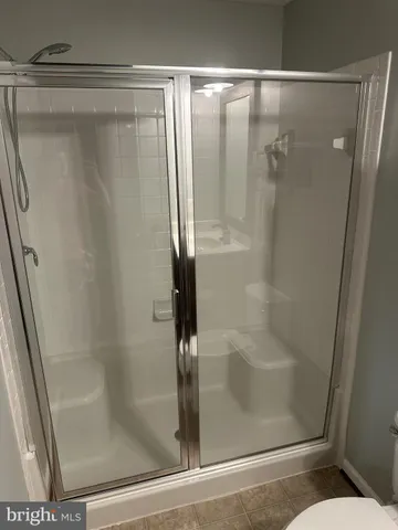 a bathroom with a glass shower door