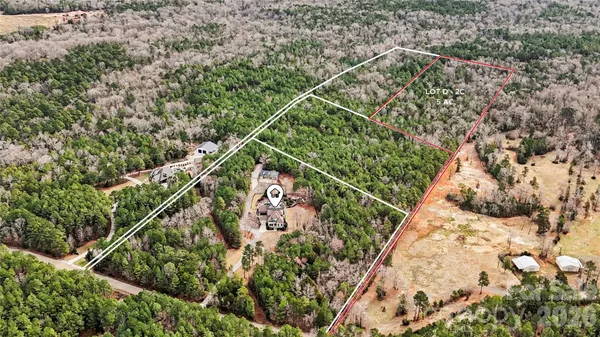 an aerial view of house with yard and mountain in the back