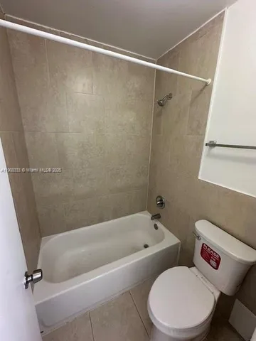 a bathroom with a toilet and a bathtub