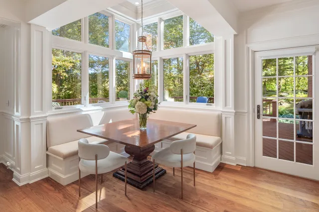 a view of a dining room with furniture wooden floor and a chandelier