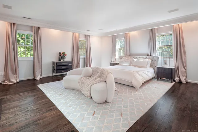 a bedroom with a bed and large window