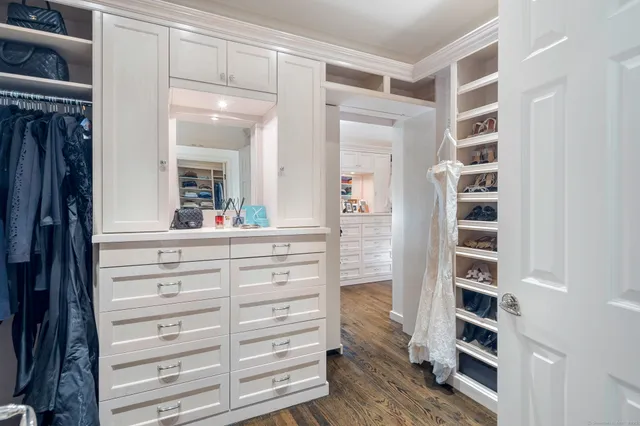 a view of walk in closet with empty racks