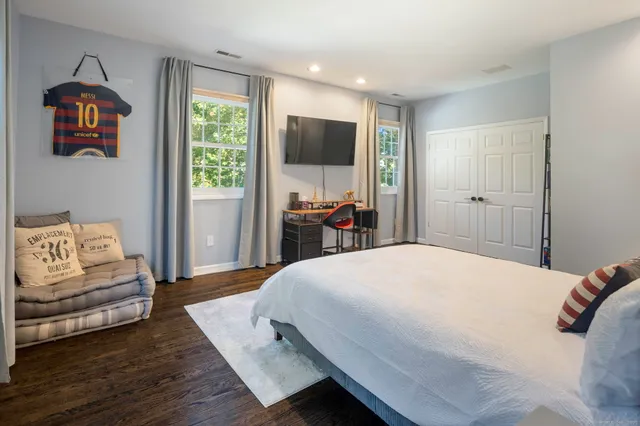 a bedroom with a large bed and a couch