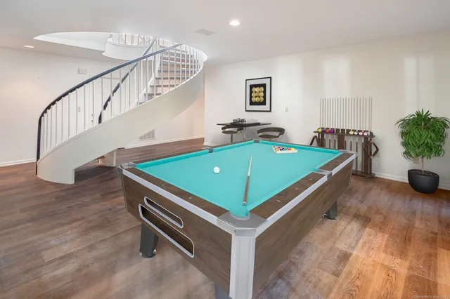 a room with pool table and windows