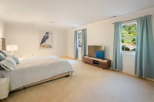 a spacious bedroom with a bed and a couch