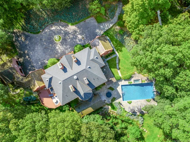 an aerial view of a house with a yard