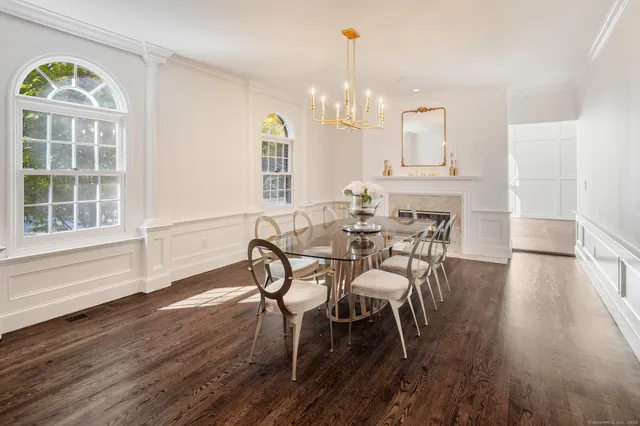 a view of a a dining room with furniture window and wooden floor
