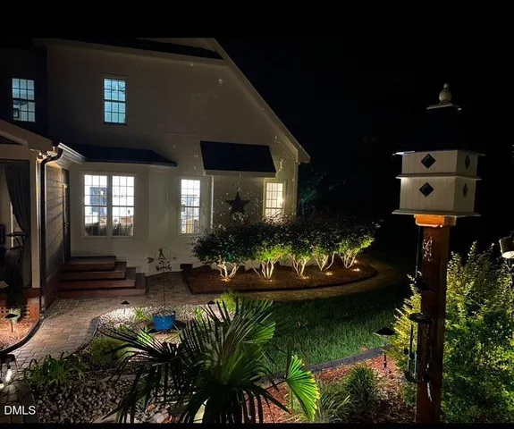 an aerial view of a house with a yard and lake view