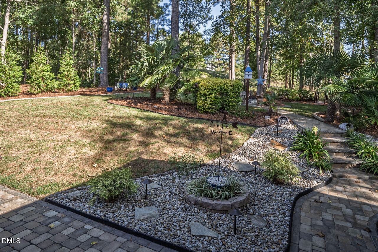 316 Chapel Ridge Drive Pittsboro, NC 27312 - Photo 32 of 69 a view of a backyard with plants and trees