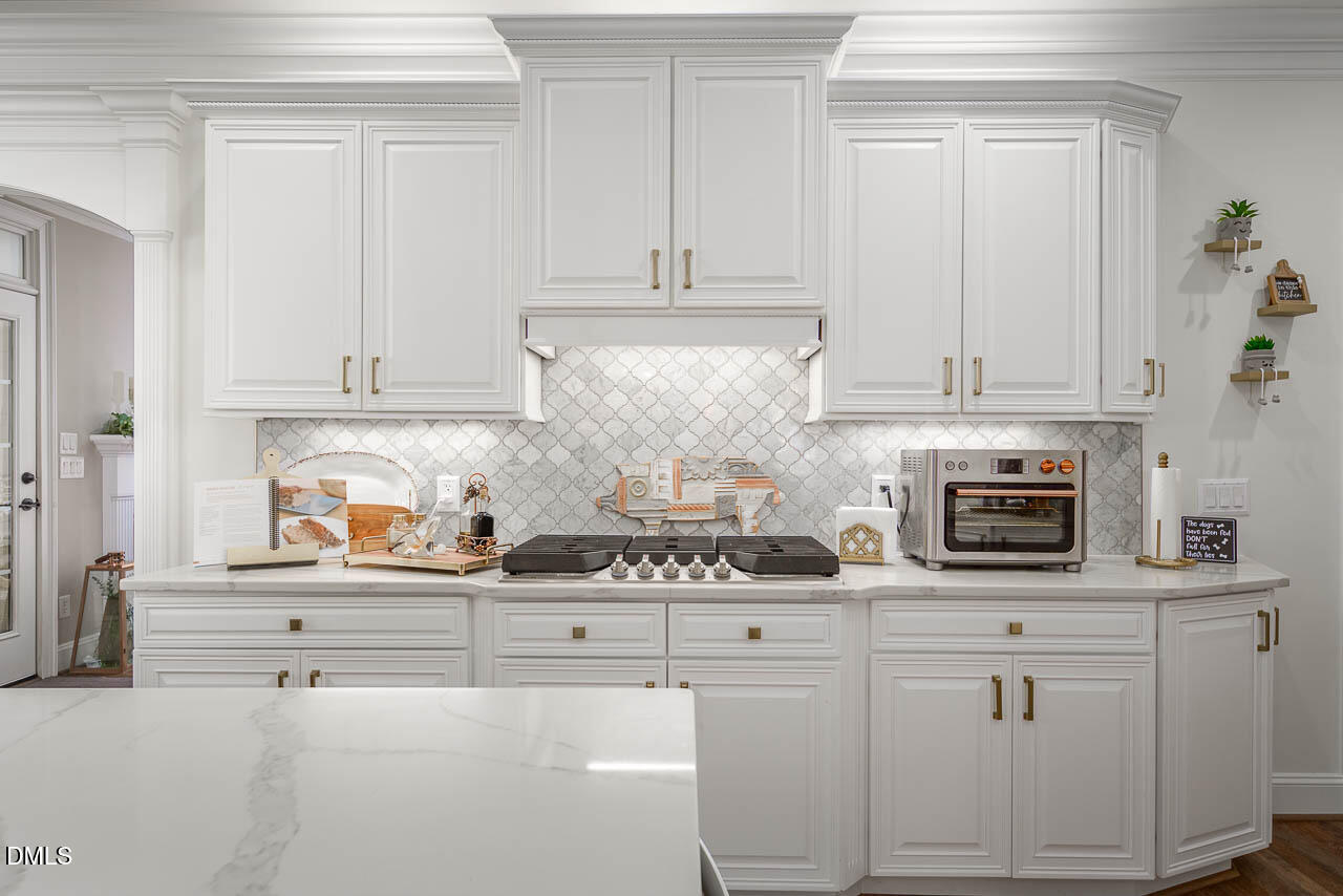 316 Chapel Ridge Drive Pittsboro, NC 27312 - Photo 38 of 69 a kitchen with white cabinets and appliances