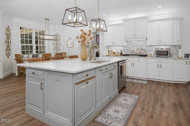 a bedroom with a bed a table and chair with wooden floor