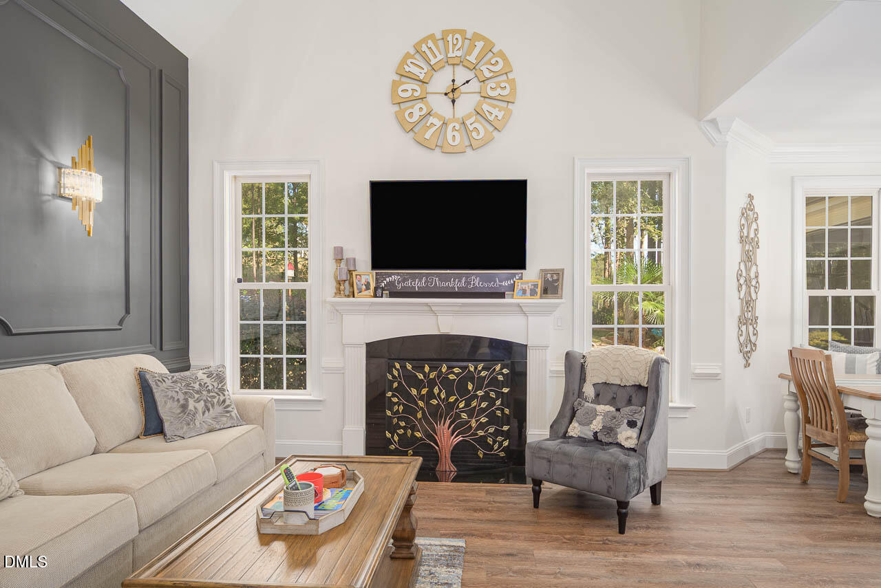 316 Chapel Ridge Drive Pittsboro, NC 27312 - Photo 44 of 69 a living room with furniture a fireplace and a flat screen tv