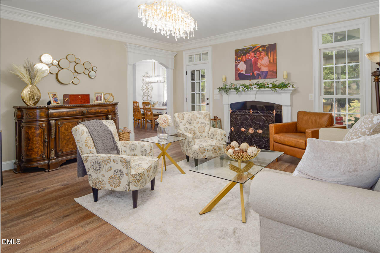 316 Chapel Ridge Drive Pittsboro, NC 27312 - Photo 46 of 69 a living room with furniture a fireplace and a flat screen tv
