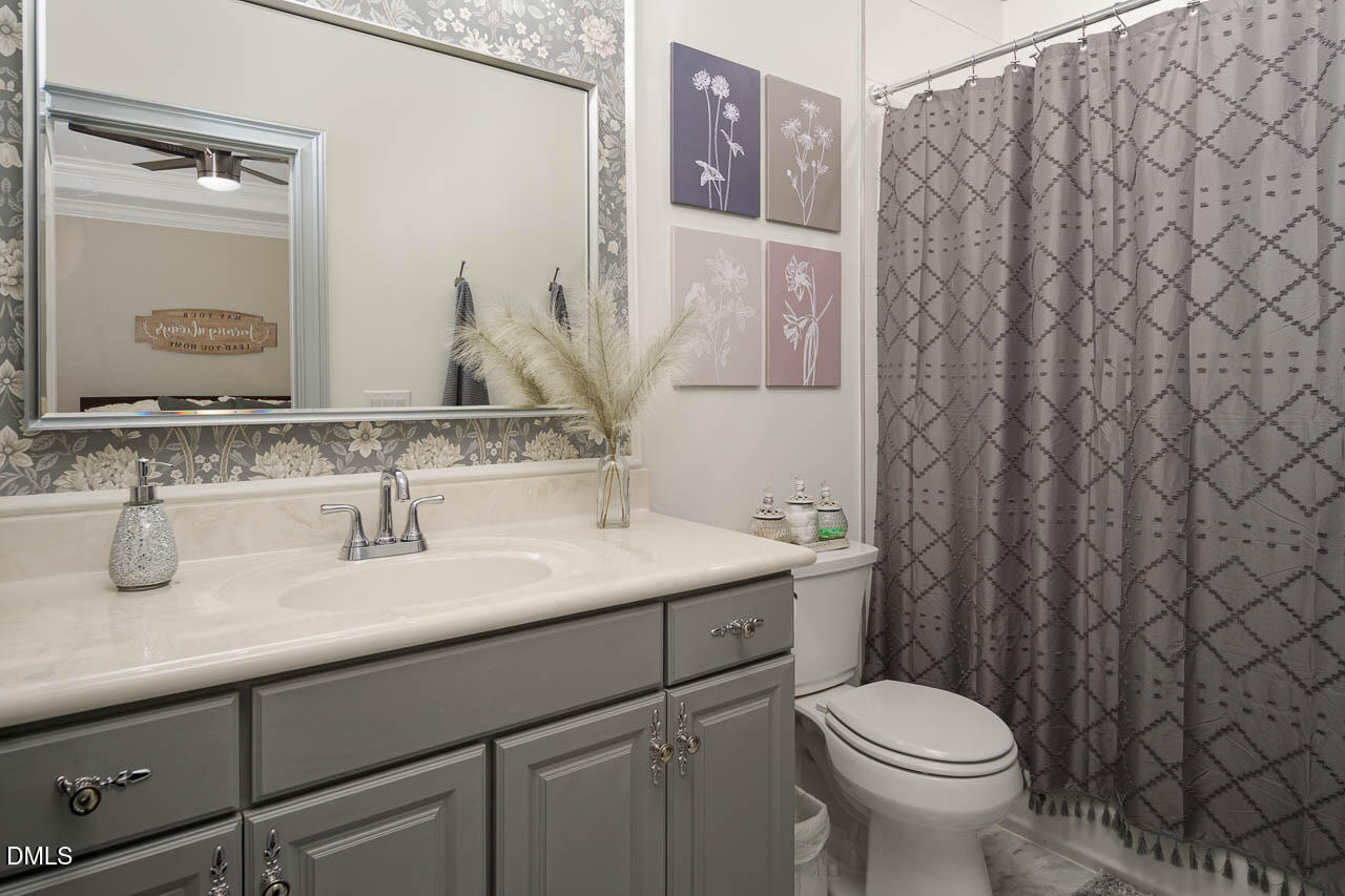 316 Chapel Ridge Drive Pittsboro, NC 27312 - Photo 63 of 69 a bathroom with a granite countertop sink and a mirror