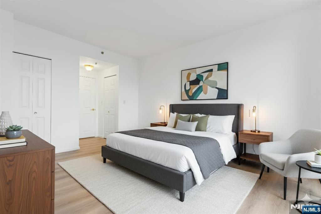 100 Old Palisade Road, Unit 1814 Fort Lee, NJ 07024 - Photo 8 of 23 a spacious bedroom with a bed and chair