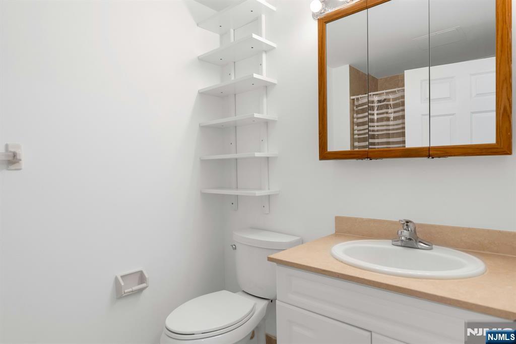 100 Old Palisade Road, Unit 1814 Fort Lee, NJ 07024 - Photo 10 of 23 a bathroom with a sink a toilet and mirror