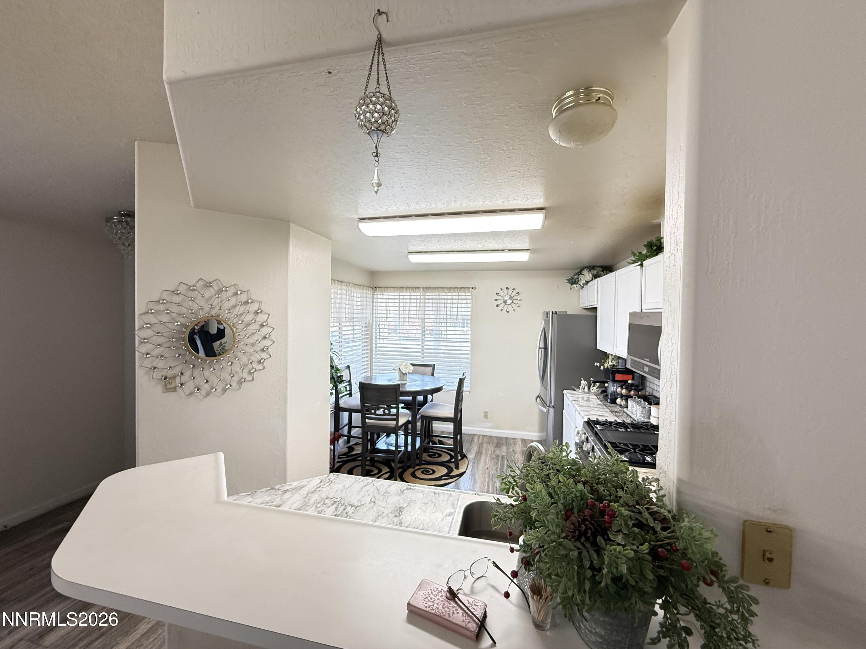 1585 Mescalero Avenue Reno, NV 89523 - Photo 11 of 13 a dining room with furniture and wooden floor