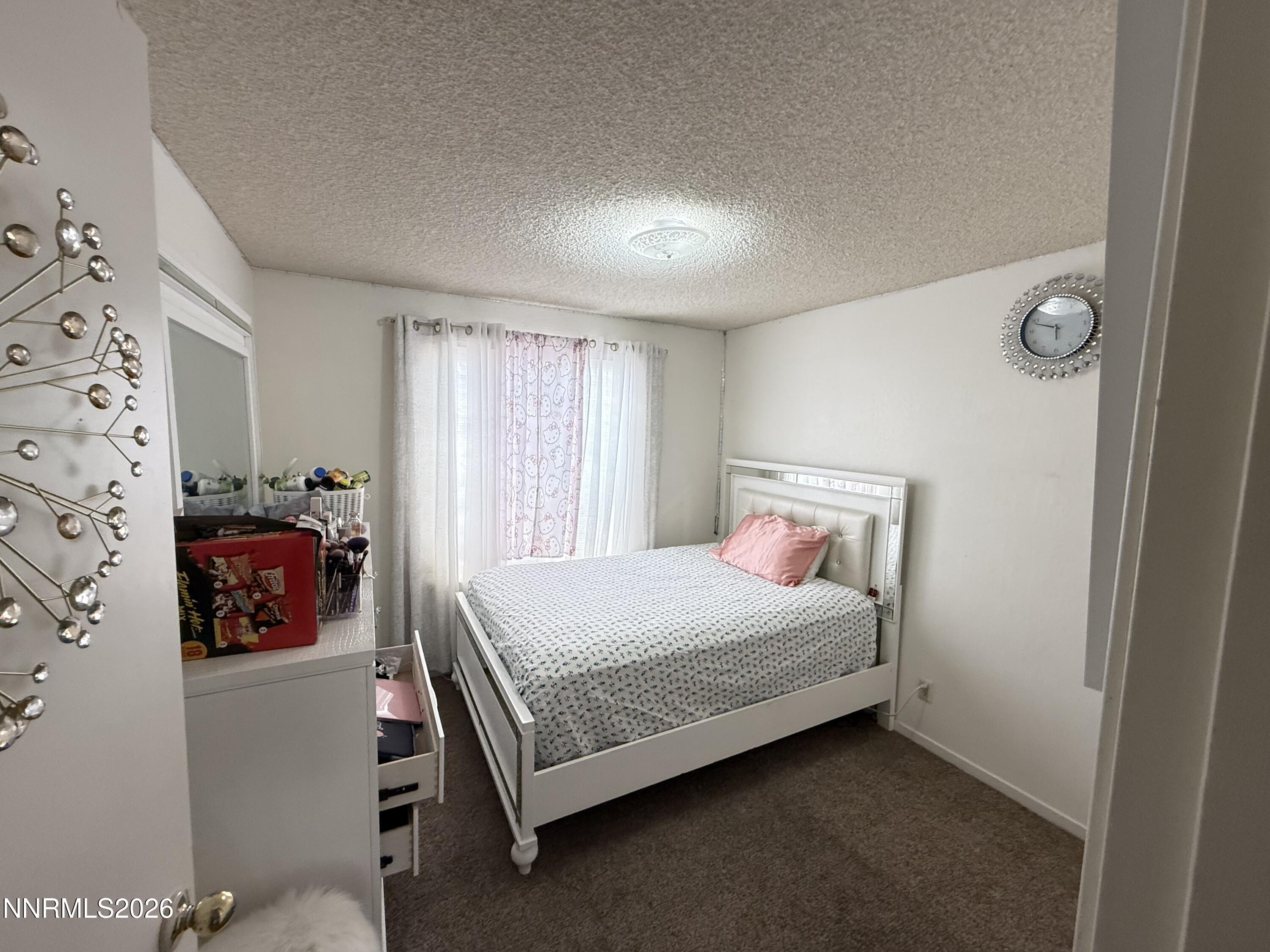 1585 Mescalero Avenue Reno, NV 89523 - Photo 4 of 13 a bedroom with a bed and a window