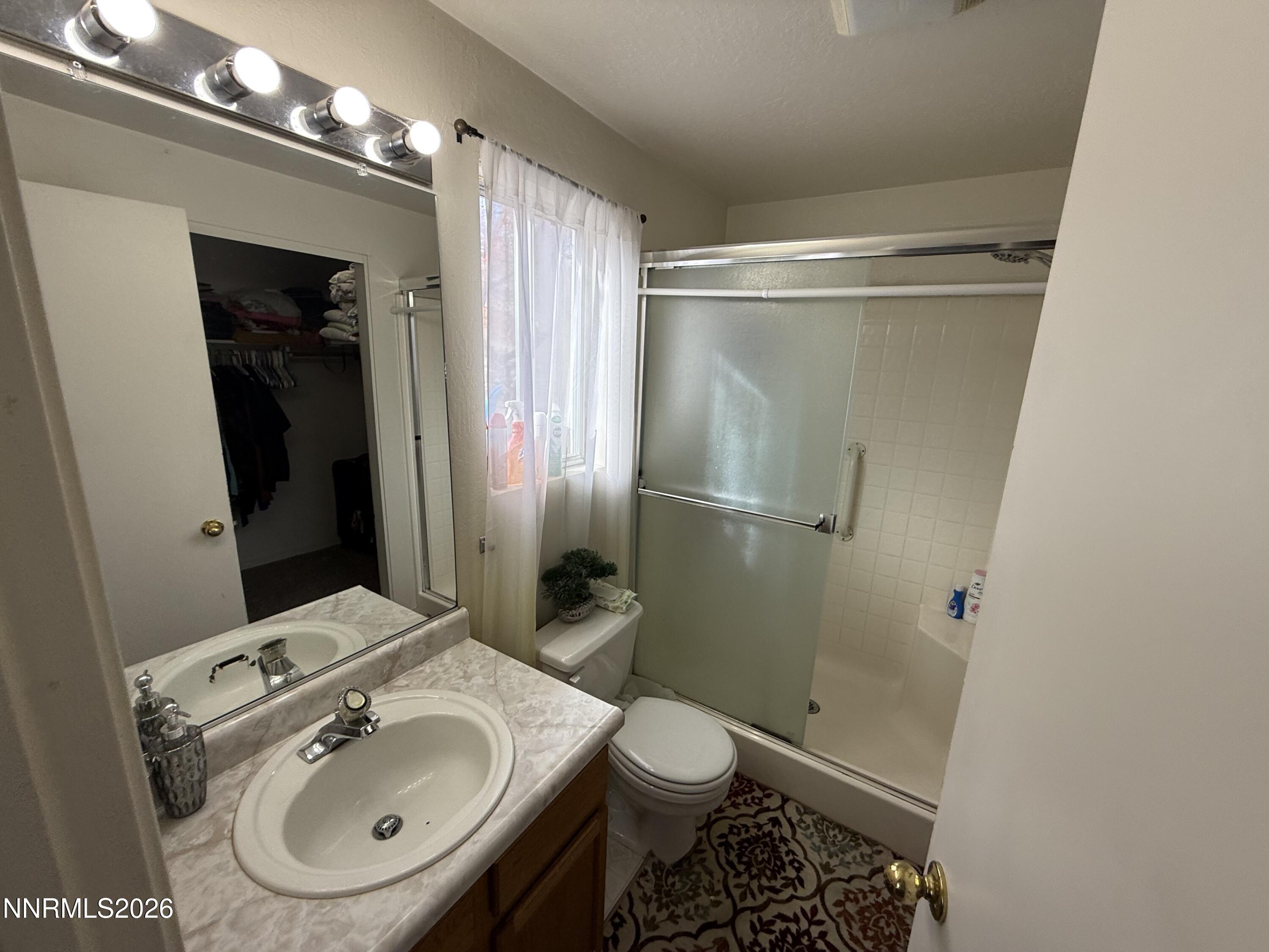 1585 Mescalero Avenue Reno, NV 89523 - Photo 8 of 13 a bathroom with a sink toilet and shower
