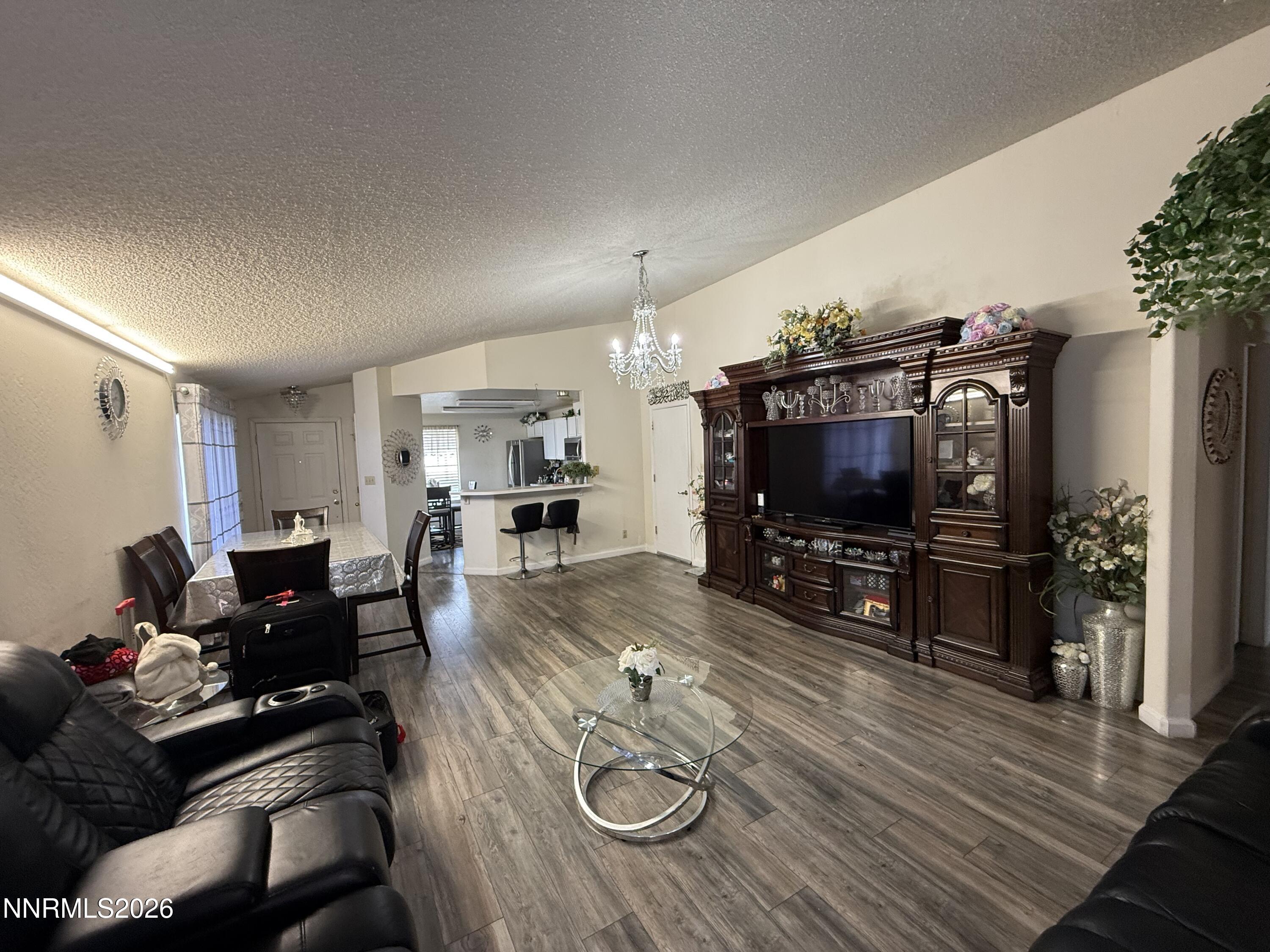 1585 Mescalero Avenue Reno, NV 89523 - Photo 9 of 13 a living room with furniture and a flat screen tv