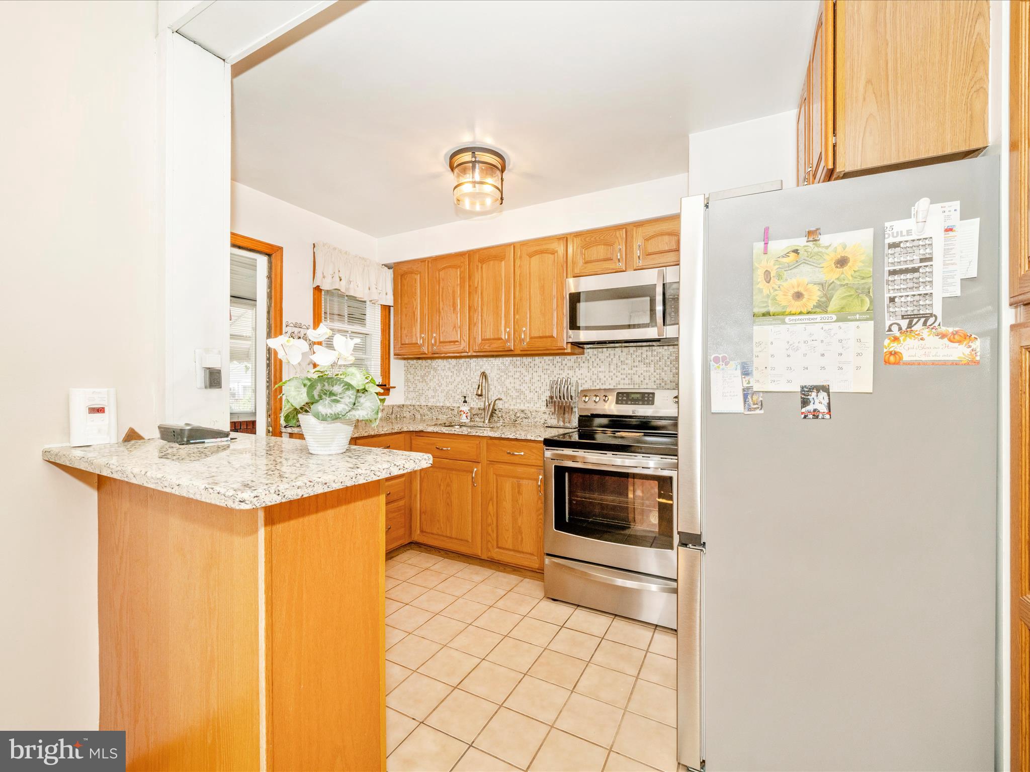 3707 North Point Road Dundalk, MD 21222 - Photo 14 of 56 a kitchen with stainless steel appliances granite countertop a refrigerator and a stove top oven