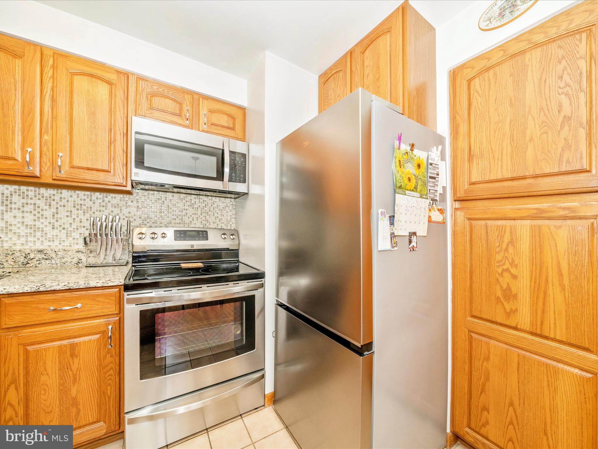 3707 North Point Road Dundalk, MD 21222 - Photo 17 of 56 a kitchen with stainless steel appliances granite countertop a refrigerator and a stove
