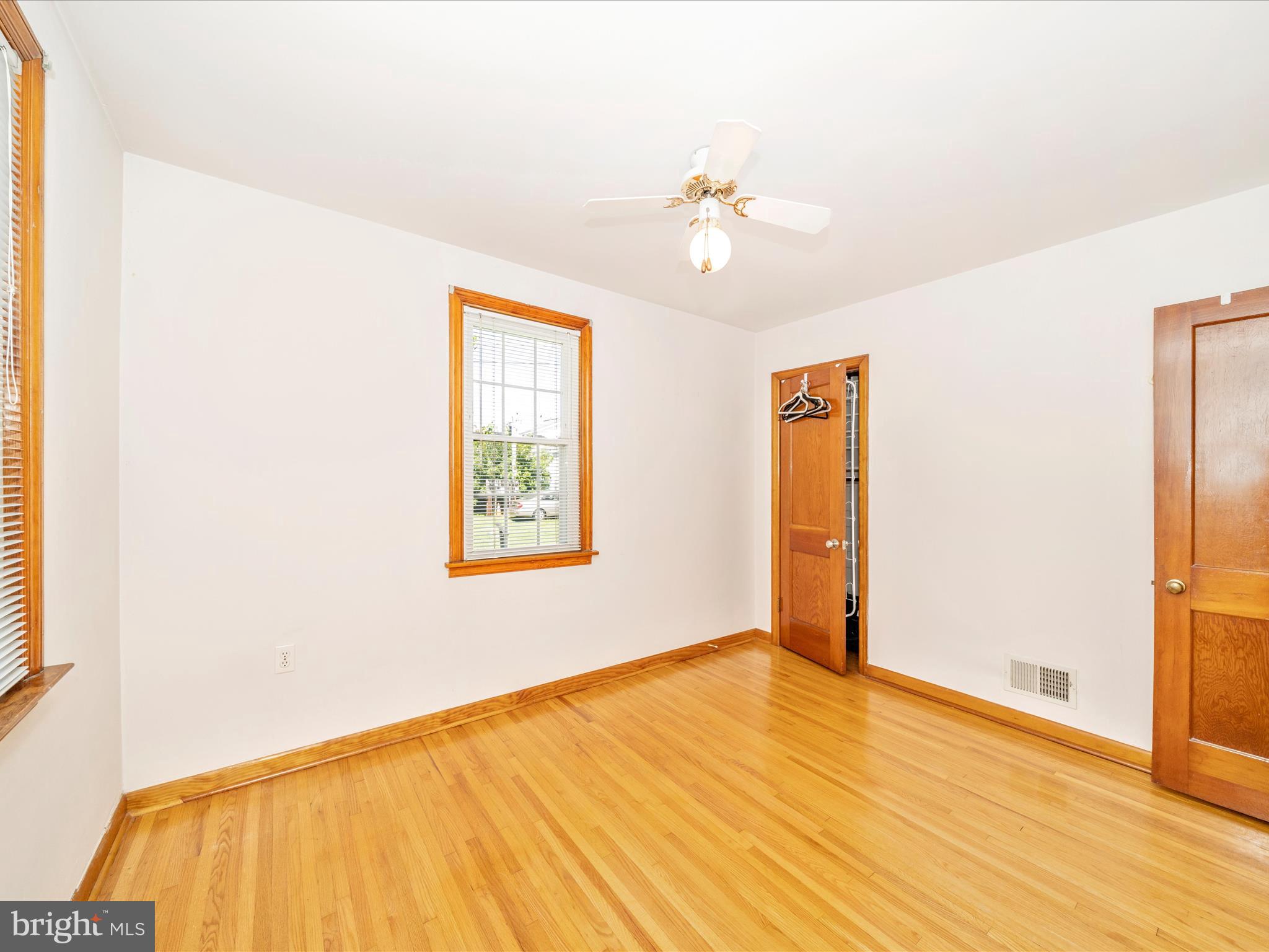 3707 North Point Road Dundalk, MD 21222 - Photo 26 of 56 a view of an empty room with wooden floor and a window
