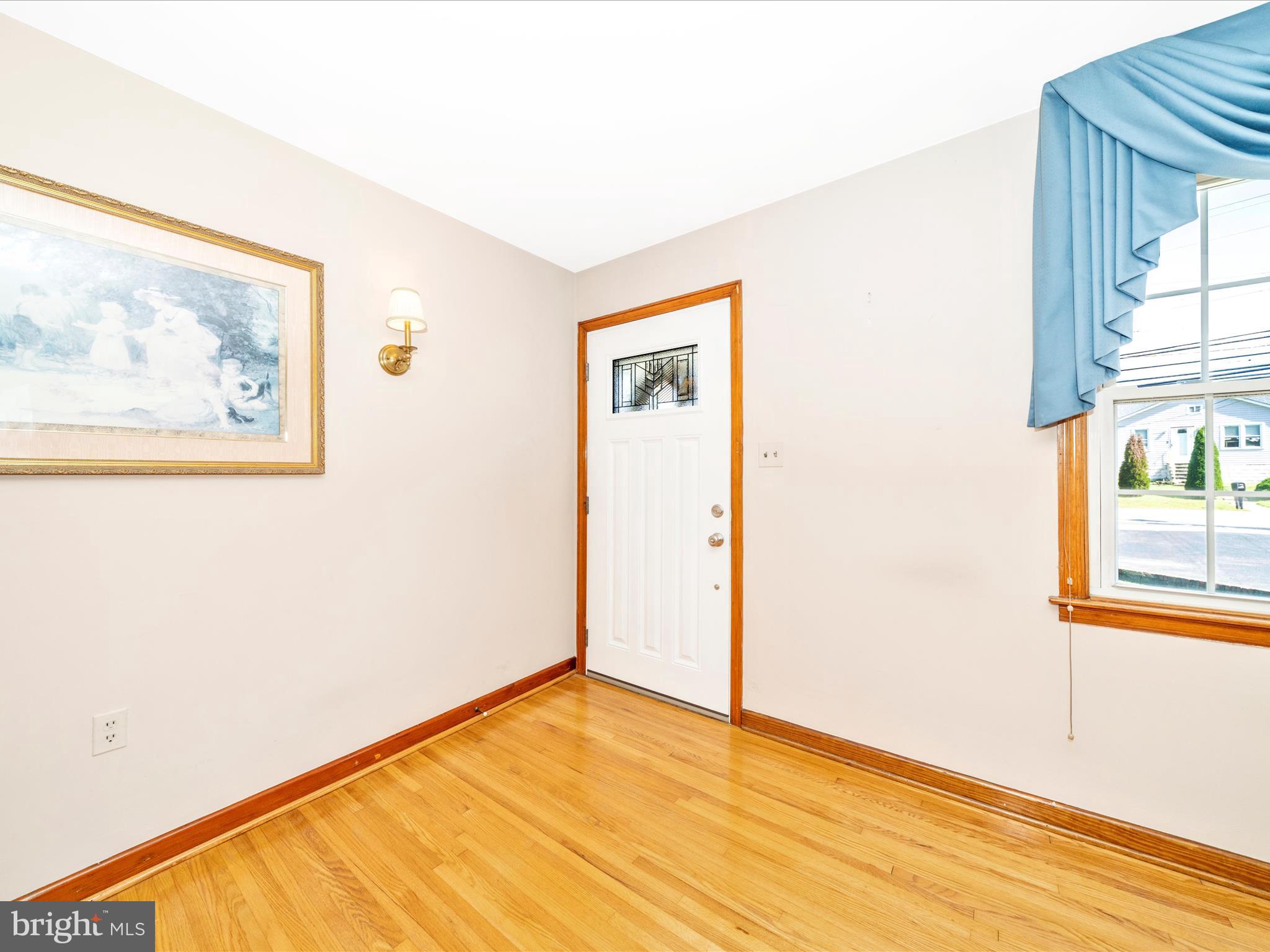 3707 North Point Road Dundalk, MD 21222 - Photo 5 of 56 a view of an empty room with wooden floor and a window