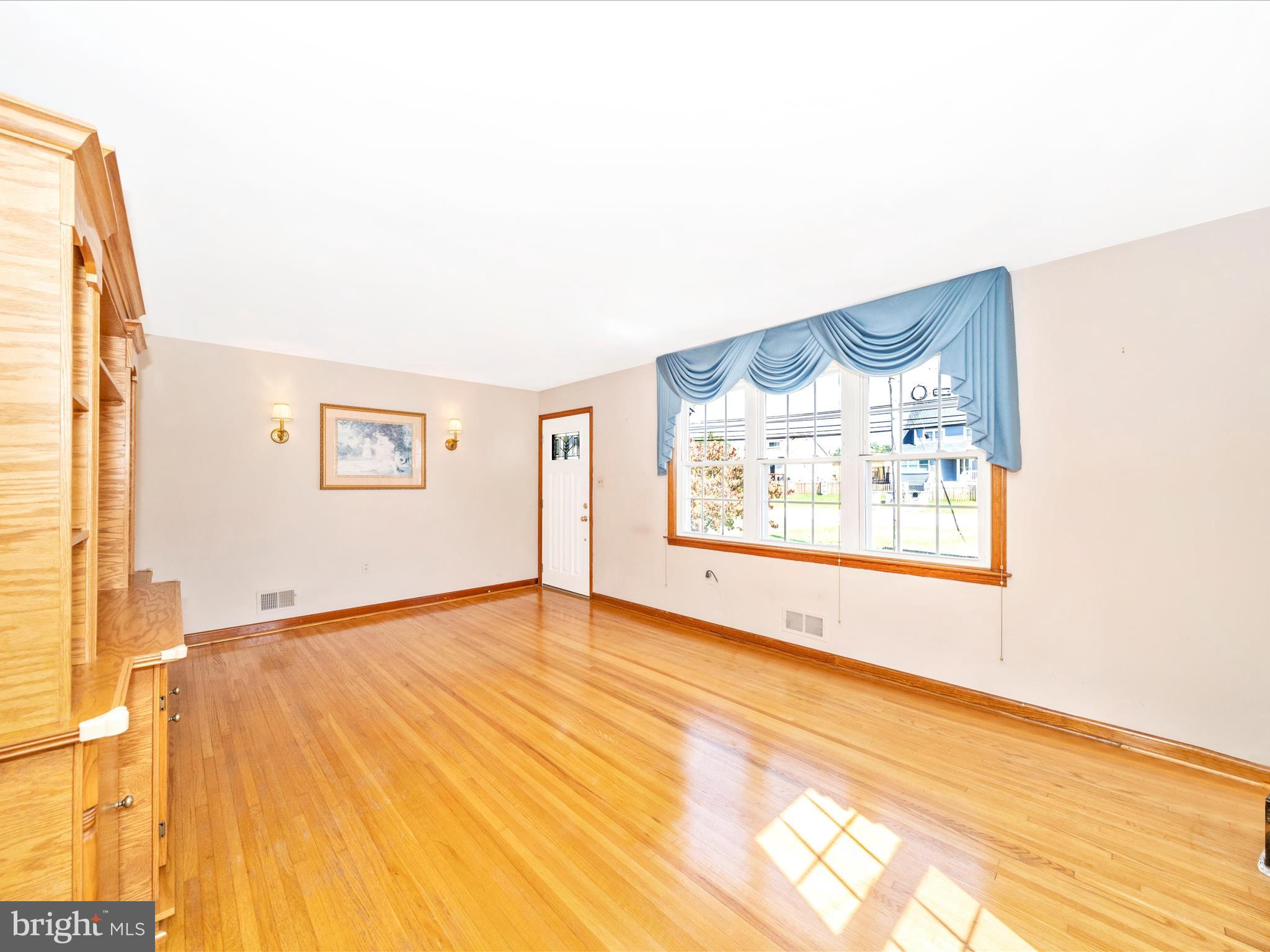 3707 North Point Road Dundalk, MD 21222 - Photo 7 of 56 a view of a big room with wooden floor and a window