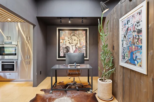 a living room with a couch and a potted plant