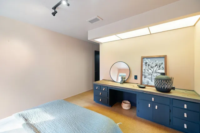 a view of walk in closet with clothes