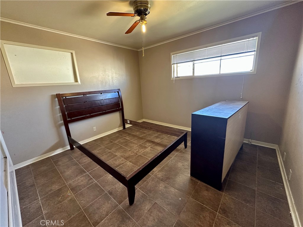 1602 Collins Street Needles, CA 92363 - Photo 14 of 18 a wooden bench sitting in a room next to a window