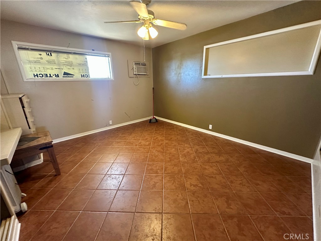 1602 Collins Street Needles, CA 92363 - Photo 15 of 18 a view of an empty room with wooden floor and a window