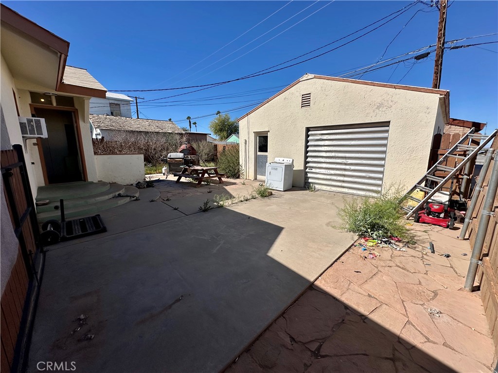 1602 Collins Street Needles, CA 92363 - Photo 17 of 18 a view of a patio with table and chairs potted plants
