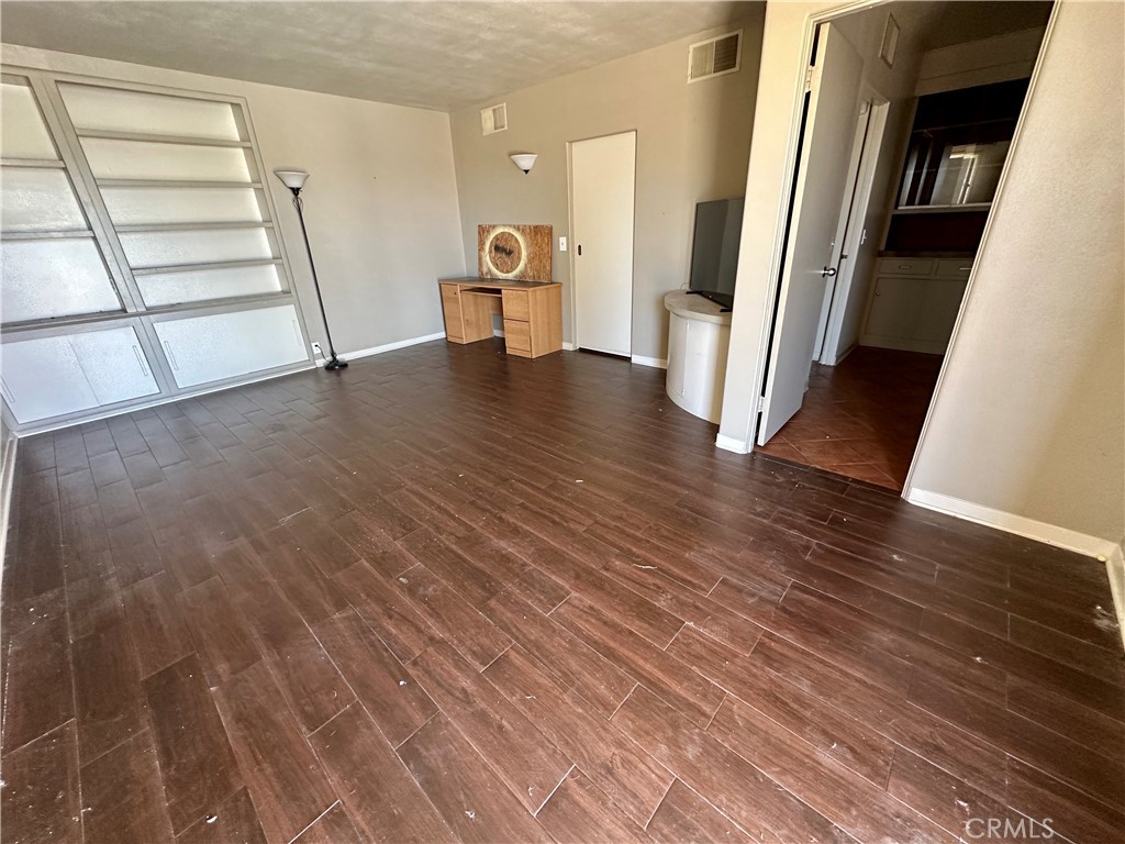 1602 Collins Street Needles, CA 92363 - Photo 3 of 18 a view of an empty room with wooden floor and stairs
