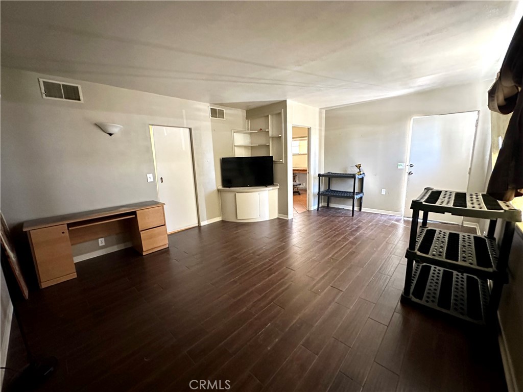 1602 Collins Street Needles, CA 92363 - Photo 4 of 18 a view of a living room a dining room and wooden floor