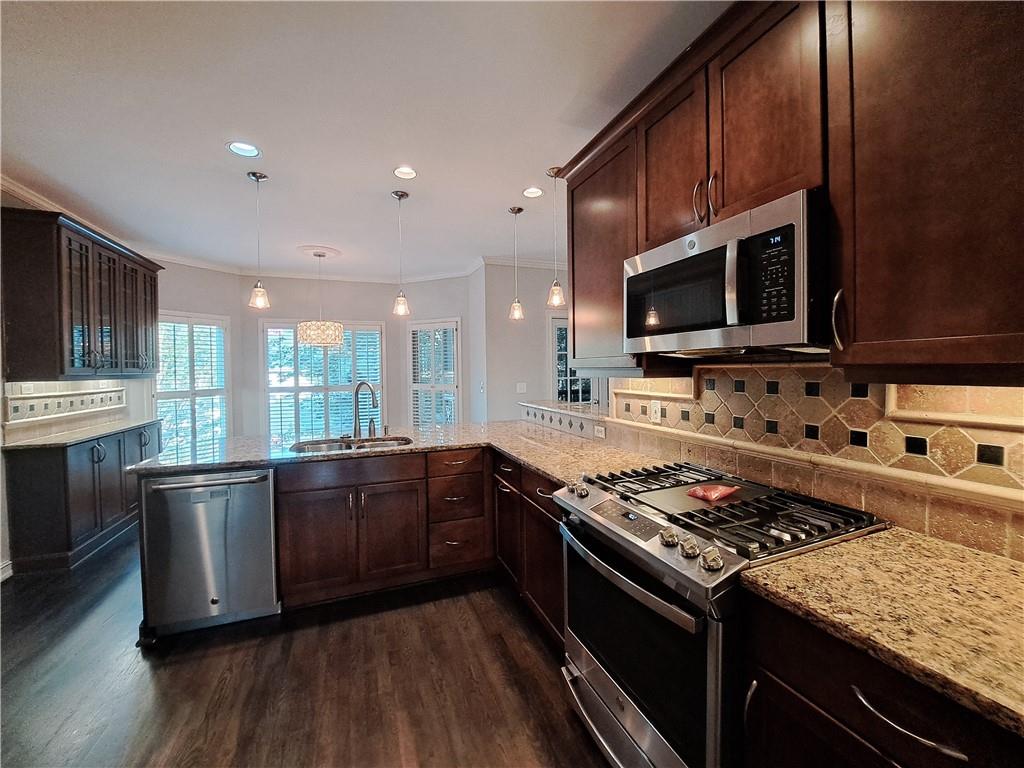2242 Lenox Walk Northeast Atlanta, GA 30319 - Photo 17 of 80 a kitchen with stainless steel appliances granite countertop a stove top oven a sink dishwasher a refrigerator and cabinets with wooden floor