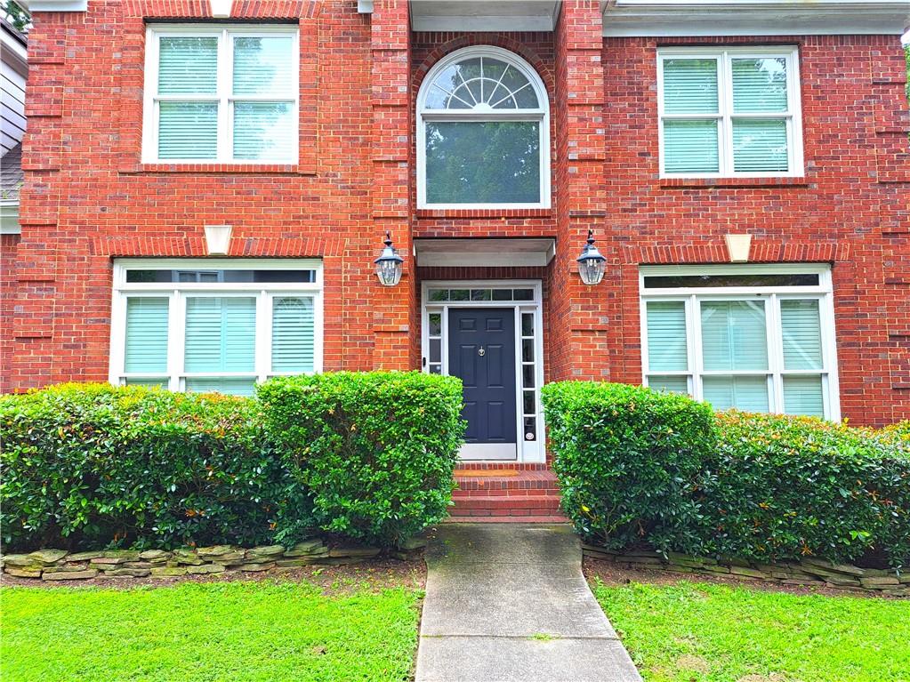 2242 Lenox Walk Northeast Atlanta, GA 30319 - Photo 2 of 80 a front view of a house with garden