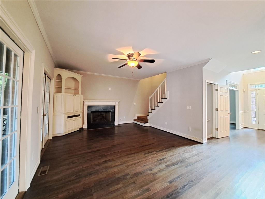 2242 Lenox Walk Northeast Atlanta, GA 30319 - Photo 25 of 80 a view of an empty room with wooden floor fireplace and a window